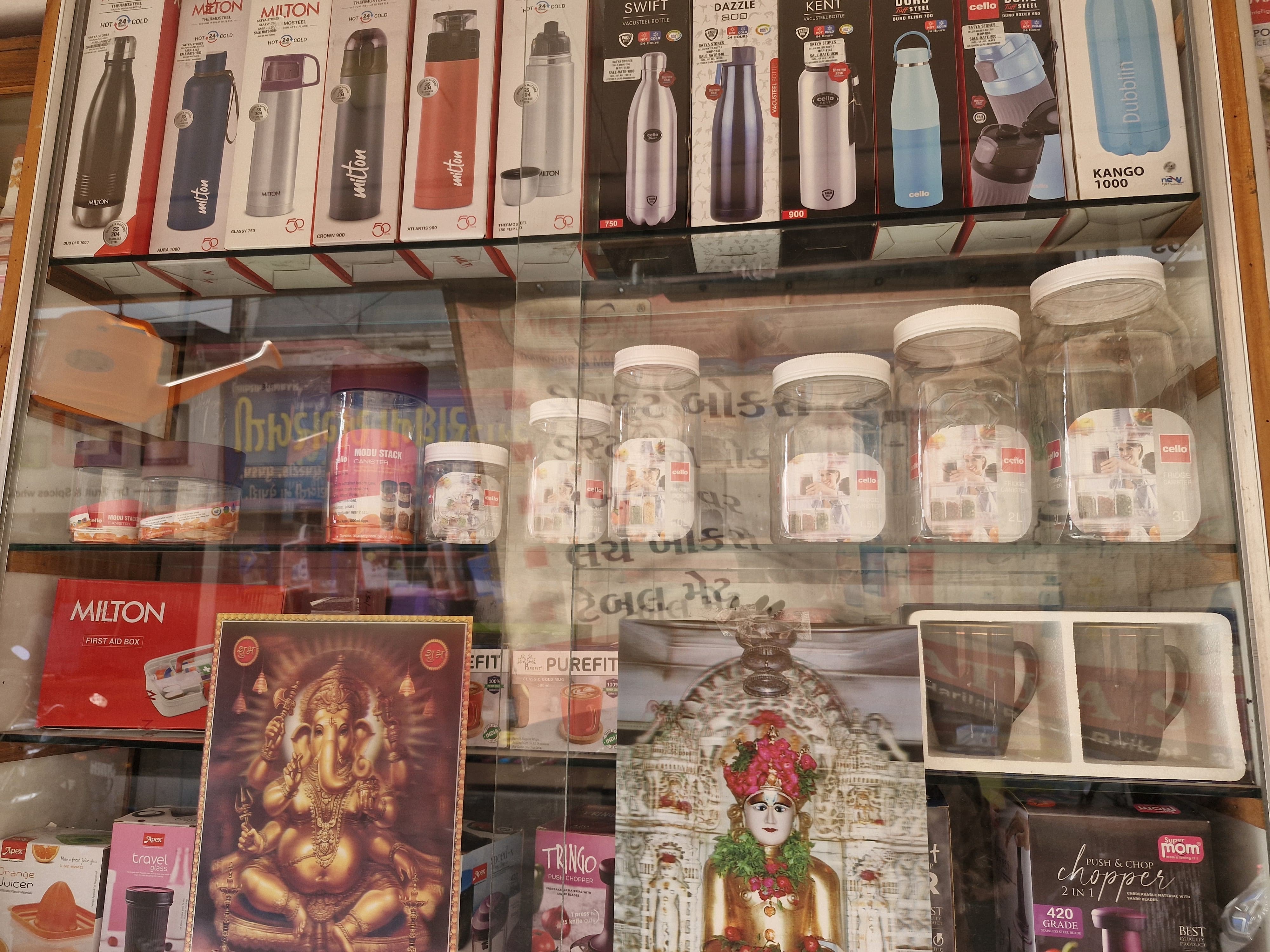 Glass display cabinet with Milton thermoses and water bottles collection
